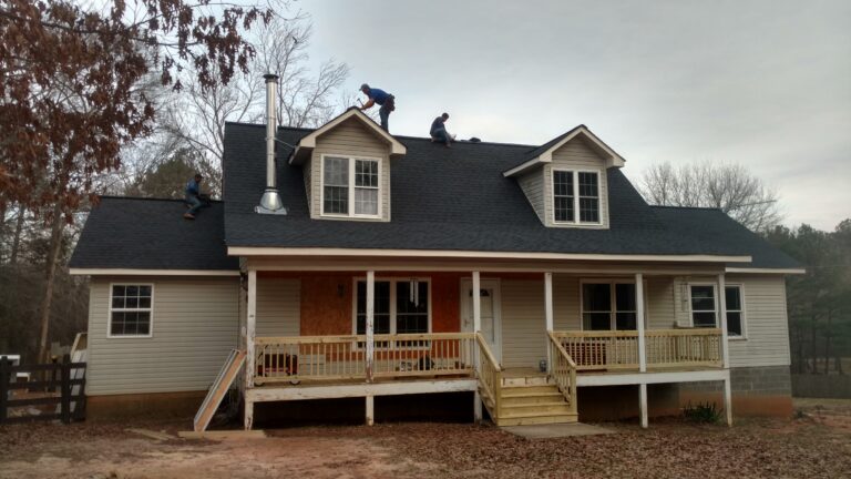 workers doing roofing repairs on a curb roof in Georgia