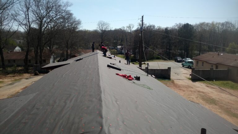 Roofing repair work in progress on a curb roof of a house in Geogia