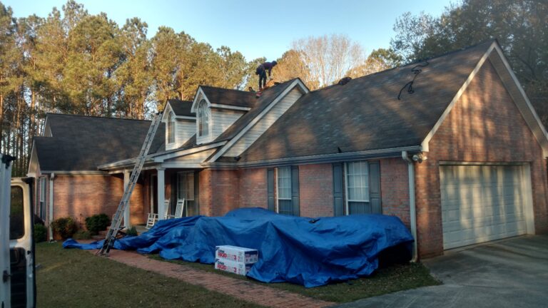 Workers inspecting a curb roof for repair