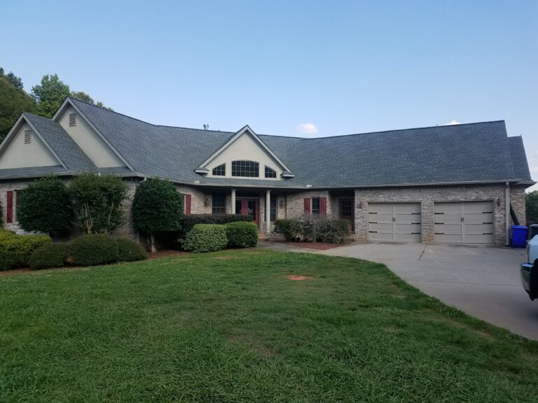 multi-level house with a gray roof repaired with asphalt shingles