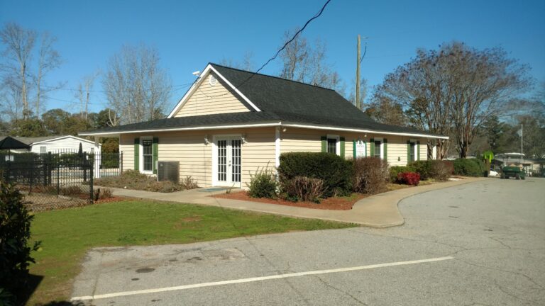 a newly repaired dark color residential roof of a house in Georgia