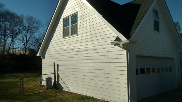 close up view of a newly repaired dark color residential roof of a house in Georgia