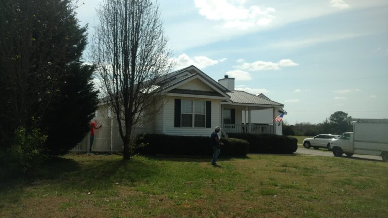 white single-story residential home with a gray residential roof repaired by Thaxton Roofing