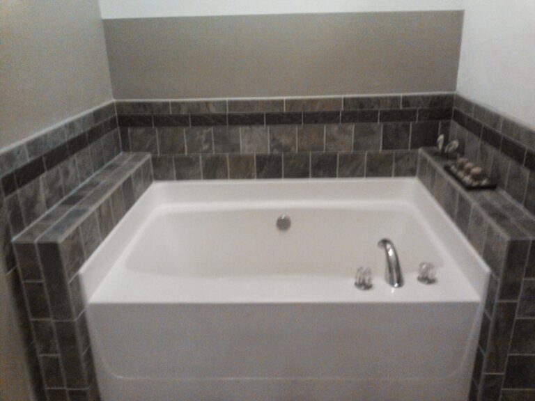 newly renovated bathroom featuring a white built-in bathtub with modern chrome fixtures